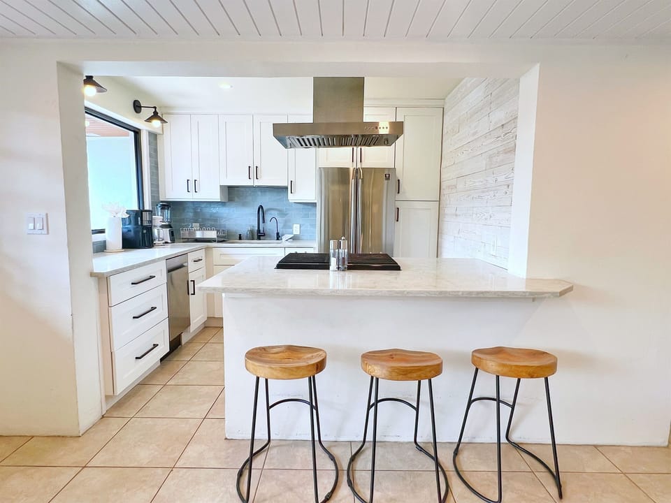 Start your day at the sleek breakfast bar, perfect for a quick coffee or casual meal. 