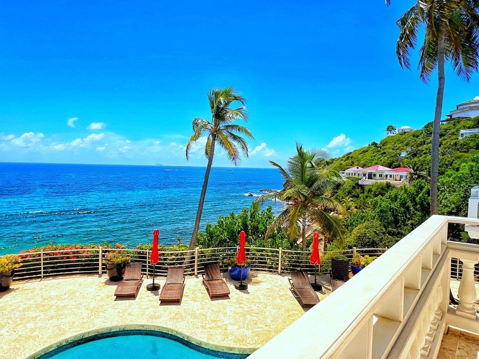 Relax poolside under swaying palms and Caribbean skies.