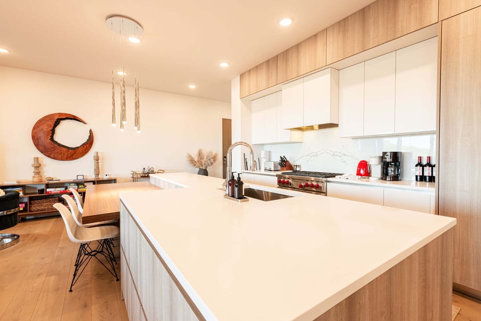 Chef's kitchen with quartz island and bar seating