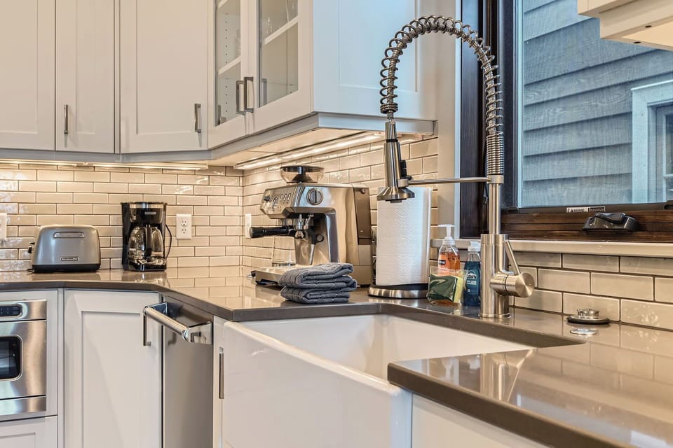Whip up your favorite drink with the built-in espresso machine or prepare a meal in the modern kitchen with sleek countertops and a farmhouse sink.