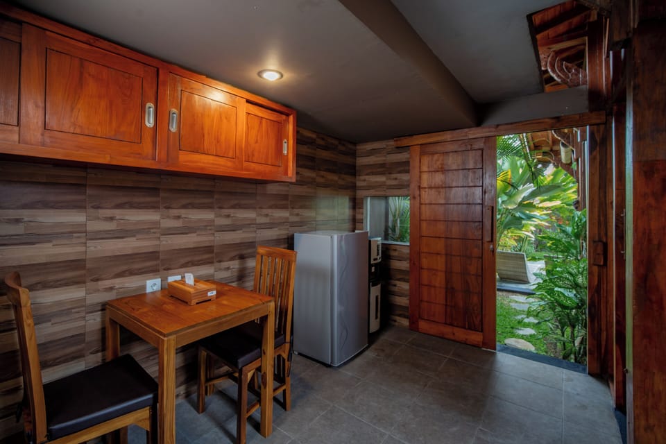 Luxury Villa, Patio, Garden View | Private kitchen | Mini-fridge, stovetop, cookware/dishes/utensils, dining tables