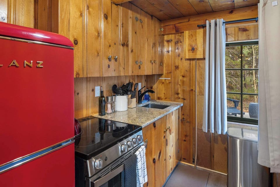 The kitchen features a microwave, refrigerator, oven/stove, coffee maker and plenty of cooking utensils!