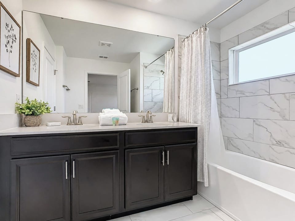 Modern Bathroom with Double Vanity and Tub Shower