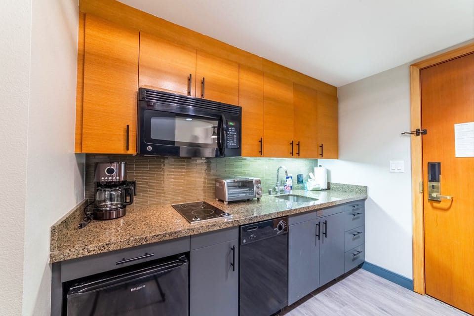 Kitchen comes fully stocked with everything needed to cook a basic meal; glass stovetop, mini-fridge, dishwasher and microwave.