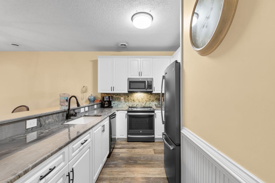 Your fully equipped kitchen awaits with granite countertops, stainless steel appliances, and everything you need to create memorable meals during your stay.