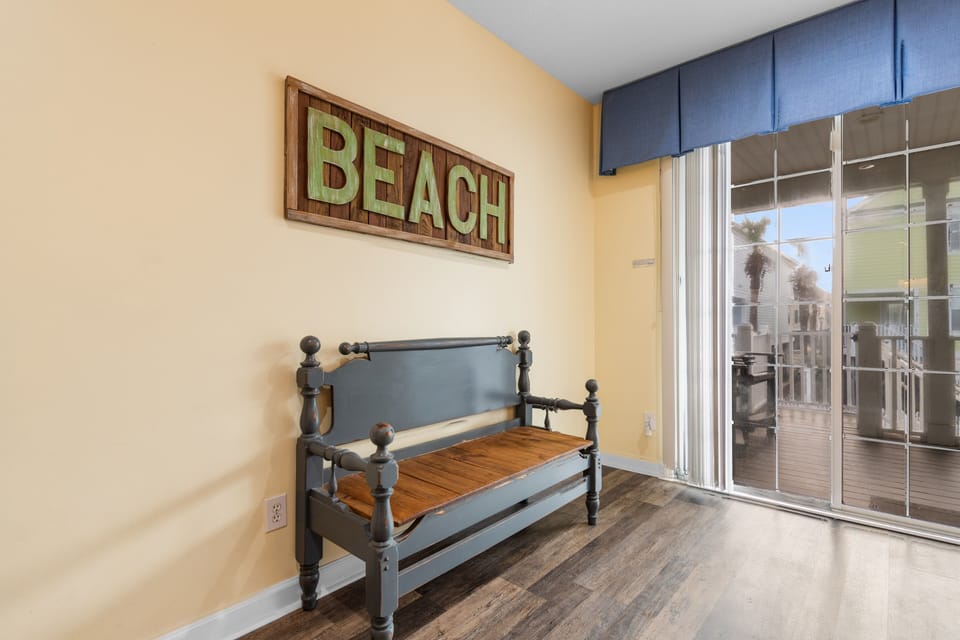 Relax in your coastal-themed room with charming beach decor and easy access to your private balcony overlooking the area.
