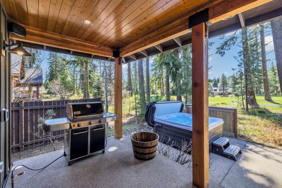 Enjoy the perfect pairing of a got tub and a sizzling grill in a cozy covered patio