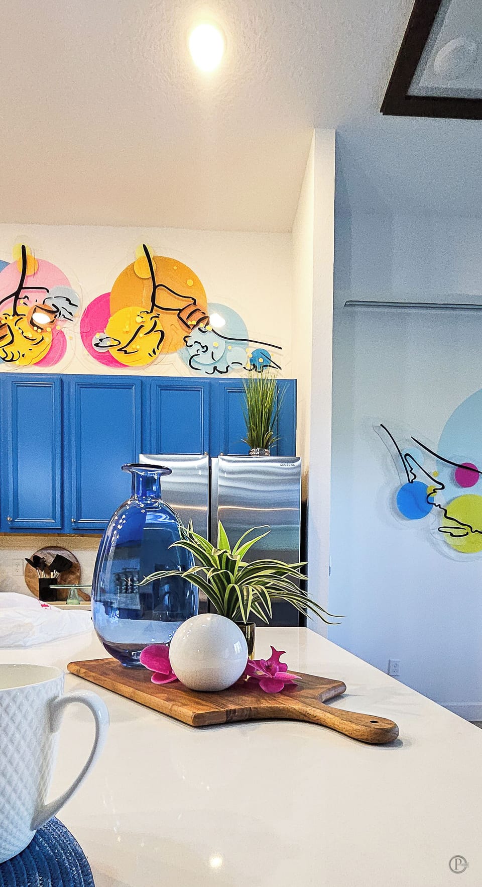 Gourmet Kitchen: Vibrant blue cabinets, sleek appliances, spacious counters.