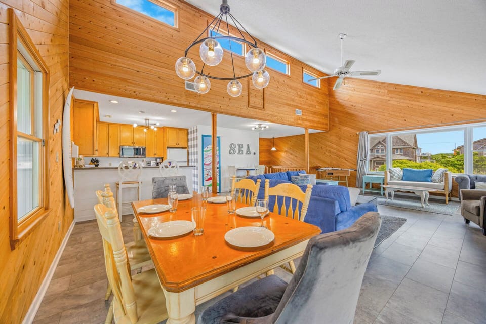 Picture yourself gathered around the dining table, sunlight streaming through the vaulted windows, with cozy seating areas and ocean-inspired touches inviting you to relax and make lasting memories.