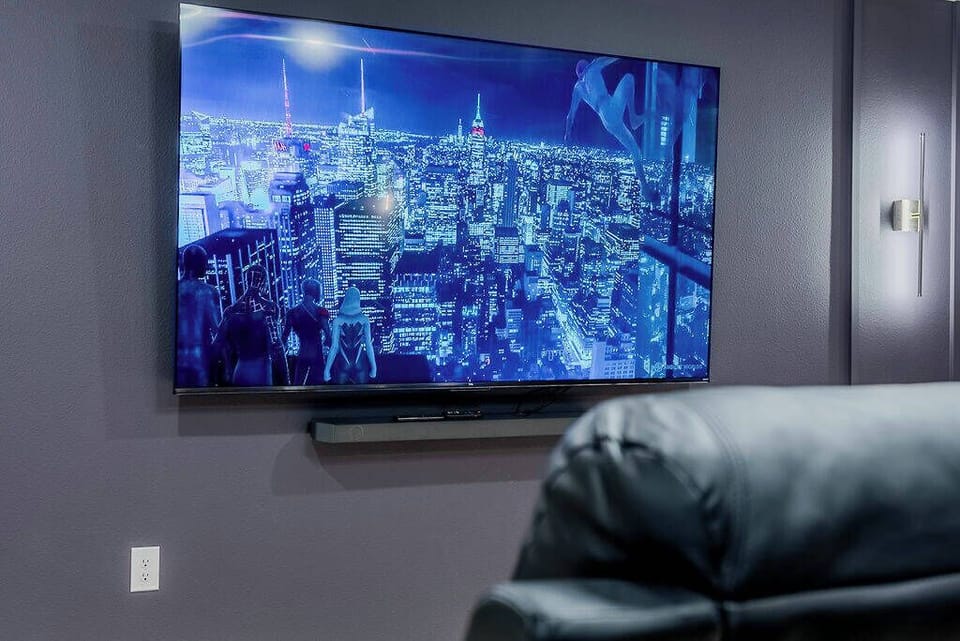 Enjoy cozy movie nights in our stylish lounge, complete with a large wall-mounted TV and breathtaking city views. Relax in sleek black leather seating, the ideal spot to unwind after a day filled with adventure.