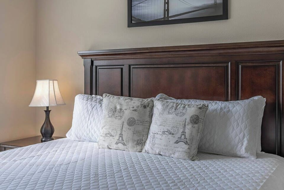 Relax in this cozy bedroom with a crafted wooden headboard and soft linens. The warm glow from the bedside lamp creates a tranquil atmosphere, making it an ideal retreat to unwind after your day's adventures.