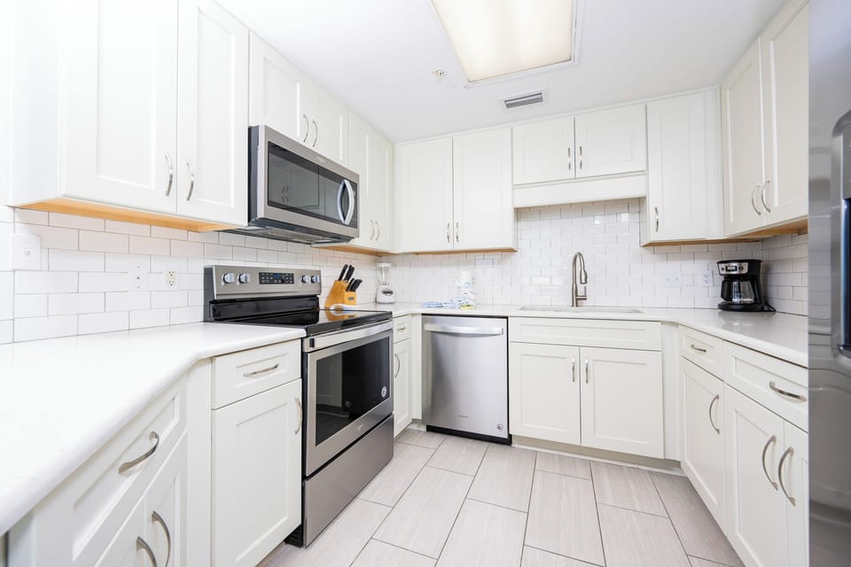 Prepare meals in this inviting kitchen featuring sleek appliances, ample counter space, and stylish cabinetry