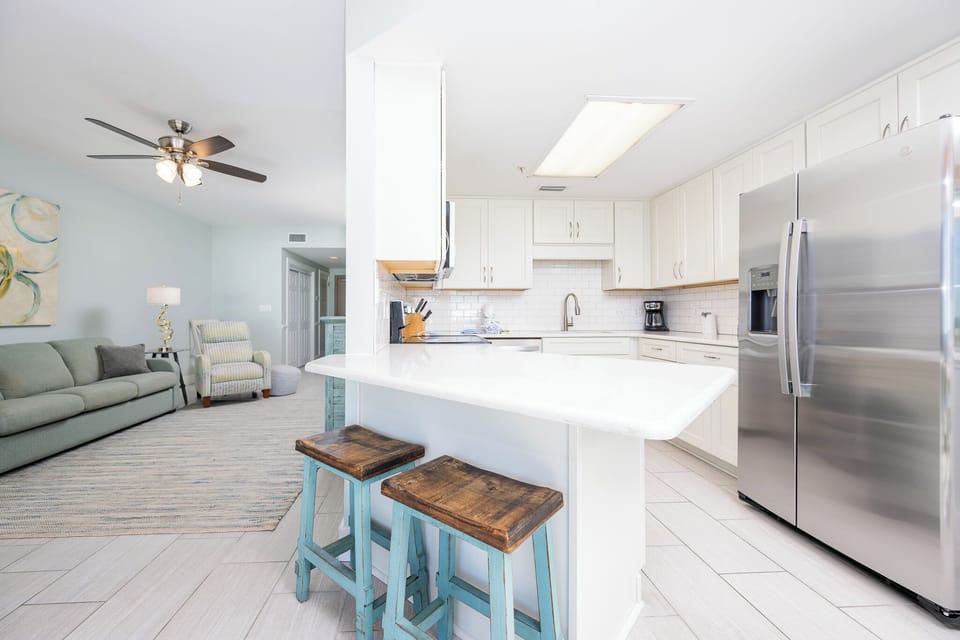 Enjoy a spacious kitchen with stainless appliances and cozy bar seating, perfect for meals and relaxation