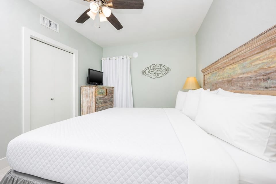 Relax in this comfortable bedroom featuring a king bed, stylish decor, and a TV for your entertainment