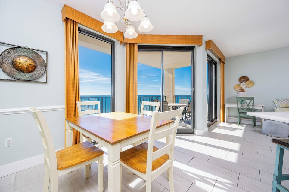 Dine with a view at the bright table, surrounded by large windows that invite in natural light and fresh gulf air