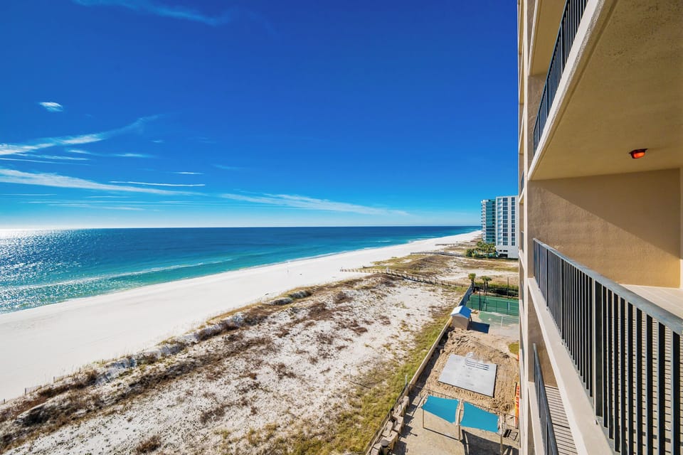 Enjoy breathtaking views of the shimmering water and bright sky from your spacious balcony