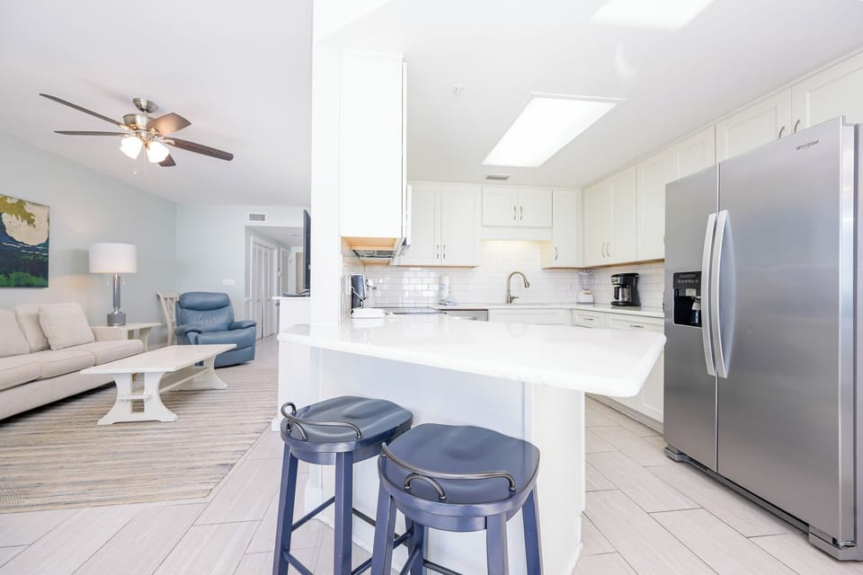 Gather around the kitchen bar with stools, perfect for casual meals and conversations in this inviting space
