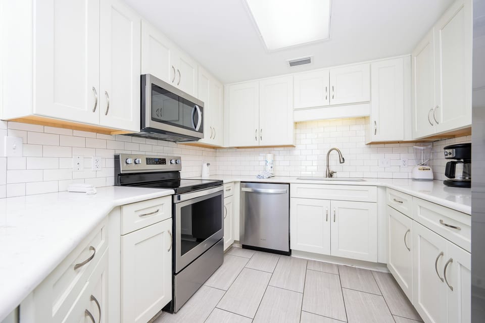 Prepare meals in this bright kitchen featuring stainless appliances, ample counter space, and an inviting design