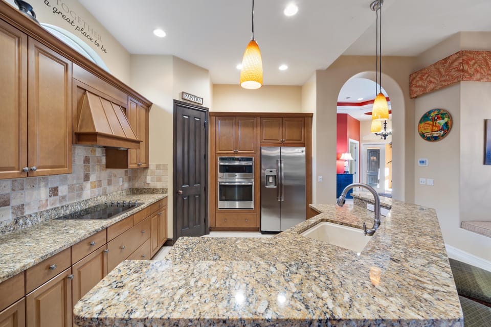 Upgraded kitchen with stainless steel appliances, island and granite.