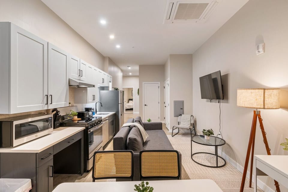 The living room’s cozy vibe makes it the perfect spot to relax, with ample seating and a warm ambiance.