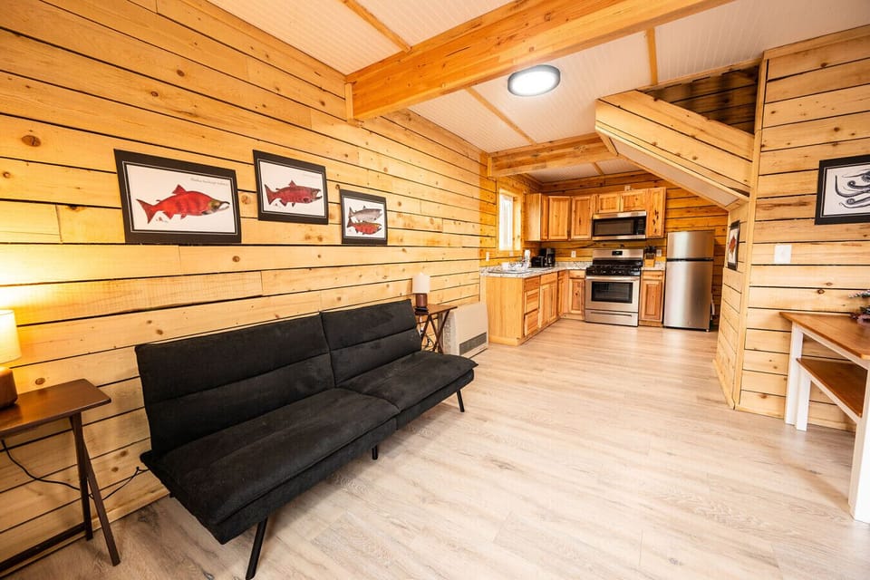 Spacious open living area with kitchen and dining space, ideal for cooking, gathering, and unwinding in the cabin.