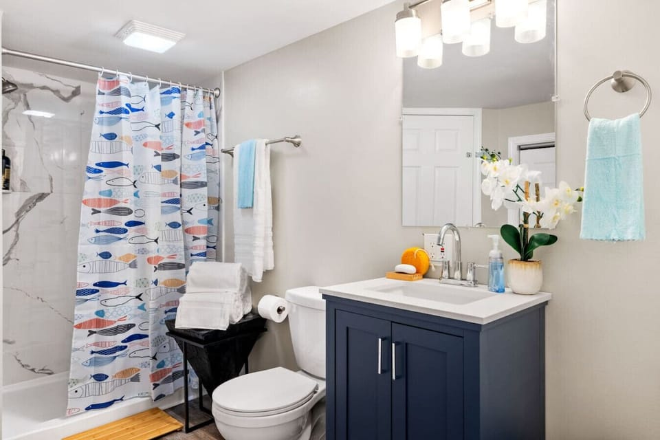 A fresh, modern bath with whimsical touches makes cleanup easy and enjoyable. This full bathroom is on the first floor, and shared by the 2 downstairs bedrooms.