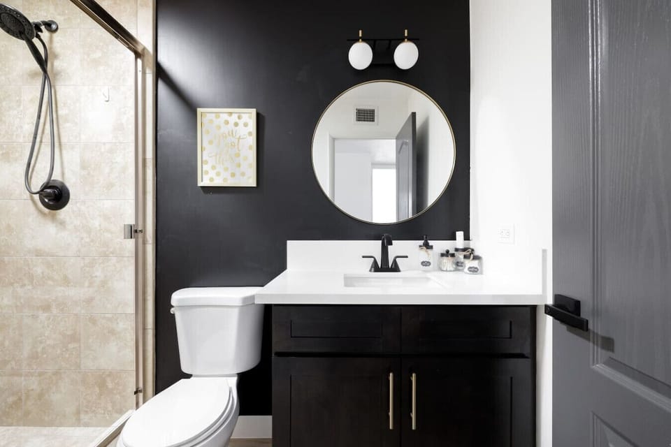 Second bathroom with a sleek stand-up shower and modern finishes.
