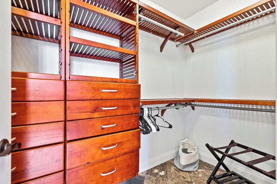 The primary bedroom features a spacious walk-in closet with built-in storage, providing plenty of room to organize and store your belongings.