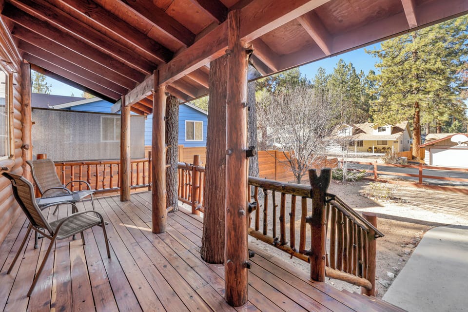 Welcoming cabin entry surrounded by towering pine trees, offering fresh mountain air and a peaceful forest setting—the perfect first impression for your Big Bear Lake getaway.