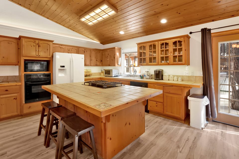 Fully equipped cabin kitchen with ample cabinetry, stove, fridge, microwave, and coffee maker—perfect for cooking meals, morning coffee, and feeling right at home on your stay.