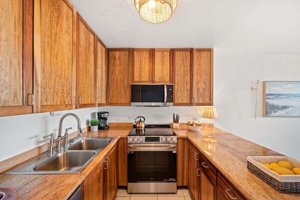 Bright kitchen with wood cabinetry, stainless appliances, and ample counter space for easy vacation cooking.