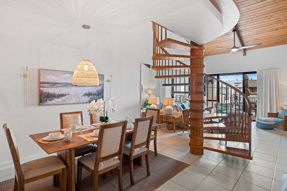 Dining area with woven pendant lighting, rattan elements, and warm natural tones for a stylish island setting.