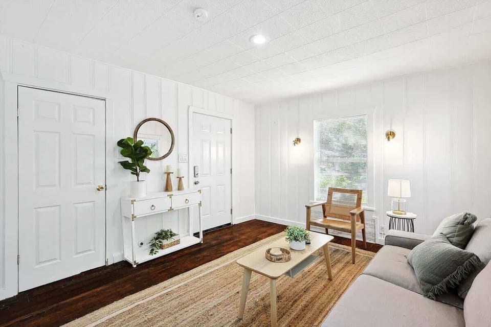 Unwind in this inviting lounge area, featuring a plush sofa, warm decor, and natural light—perfect for relaxation, movie nights, or catching up with loved ones!
