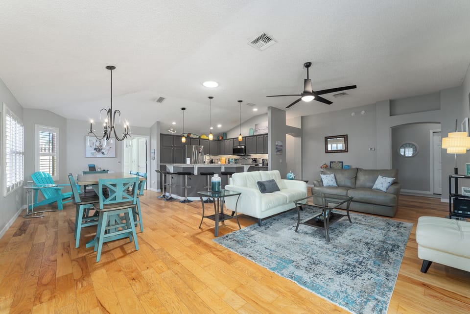 Living Room with a 75 inch TV, Dining Room, and Kitchen.  