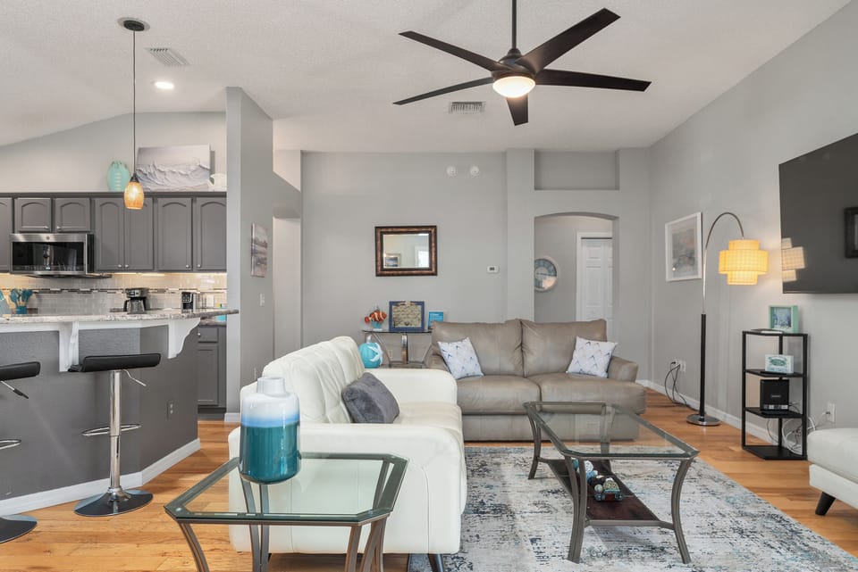 Living room with two leather loveseats. Sleeping Quarters Beyond the Living Room on the Right