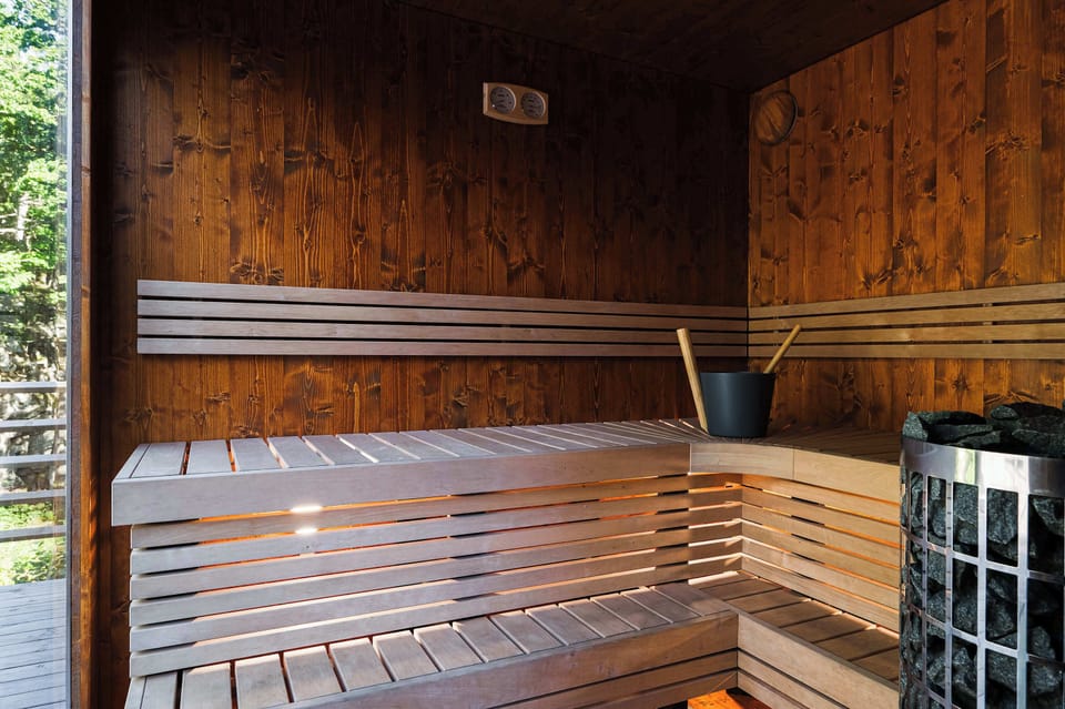 Private electric sauna with wooden benches.