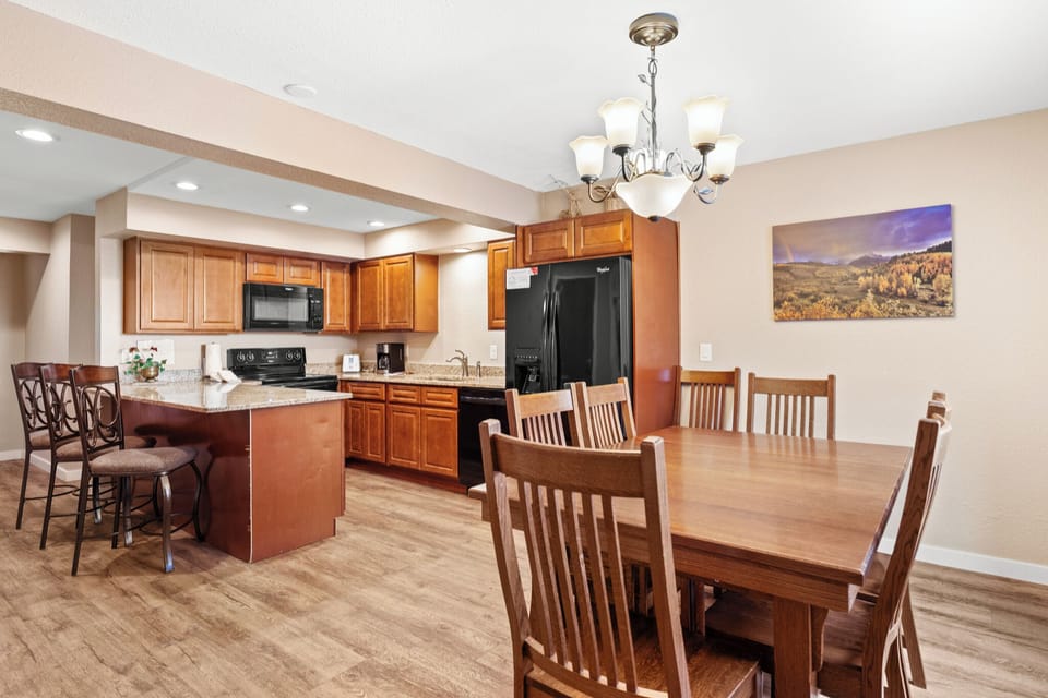 Your spacious kitchen and dining area features warm wood cabinetry, granite counters, and a welcoming table perfect for memorable meals together.