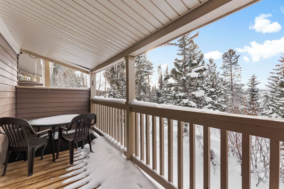 Step onto your private covered balcony and breathe in the crisp mountain air while enjoying stunning snow-covered forest views.