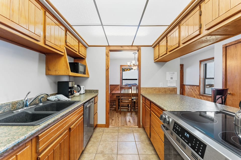 Your fully equipped galley kitchen flows into the dining area, perfect for preparing memorable meals together.