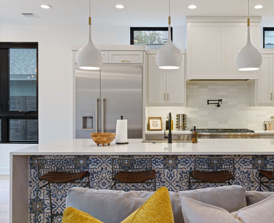 Center stage for your stay: a versatile island perfect for sharing wine with friends, casual meals, or even catching up on work. Bright pendant lights set the mood for any occasion.