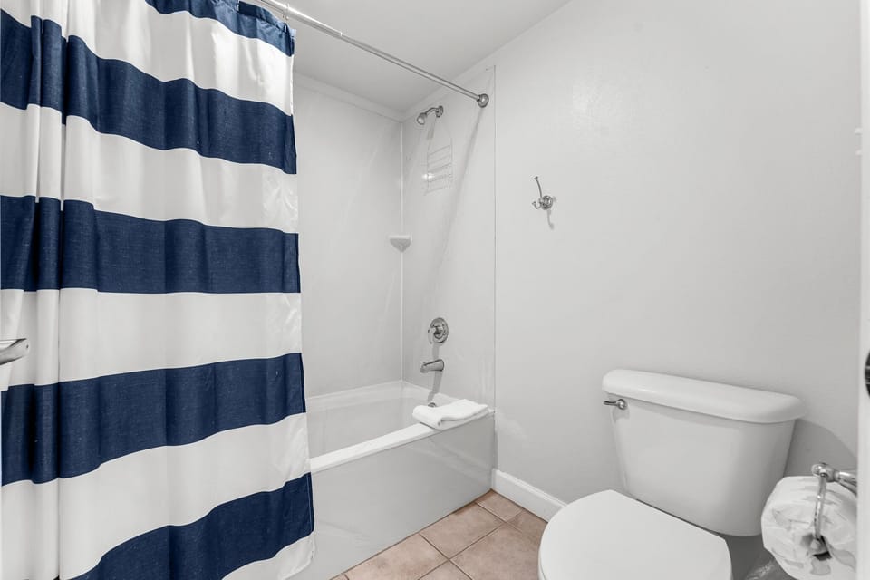 Simple bathroom with a bathtub and striped shower curtain