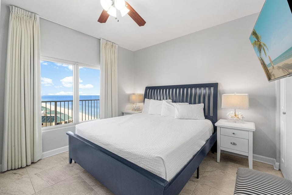 Relax in this modern bedroom with ocean views through the window.