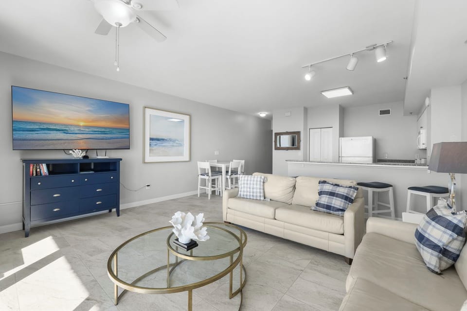 Coastal-styled living area w/ soft tones, ocean views & a laid-back, welcoming feel.