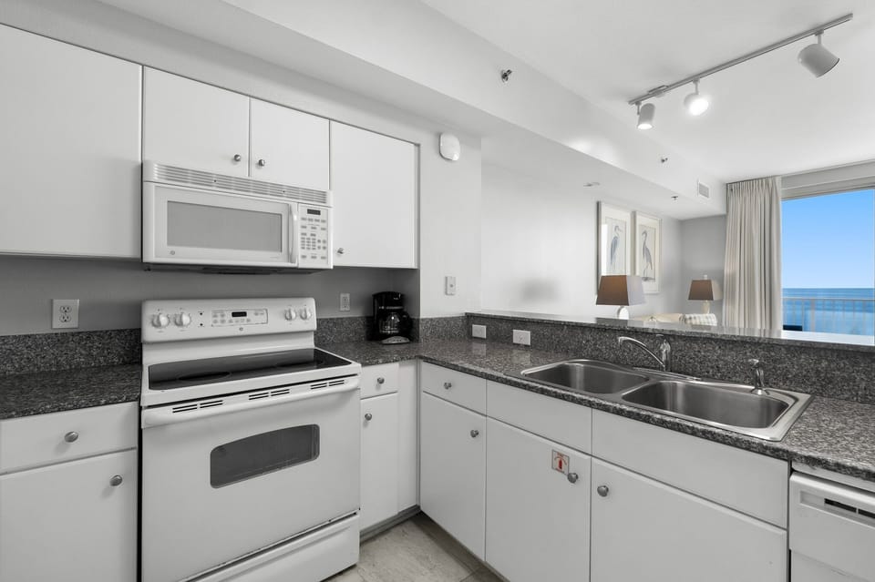 Clean white kitchen w/ full appliances & plenty of counter space for home-cooked meals.