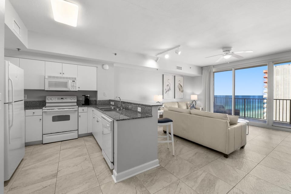 Modern kitchen and living area with ocean views from the balcony