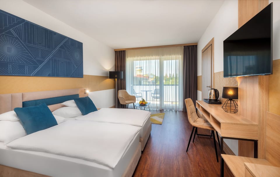 Standard Double or Twin Room | Minibar, in-room safe, desk, laptop workspace