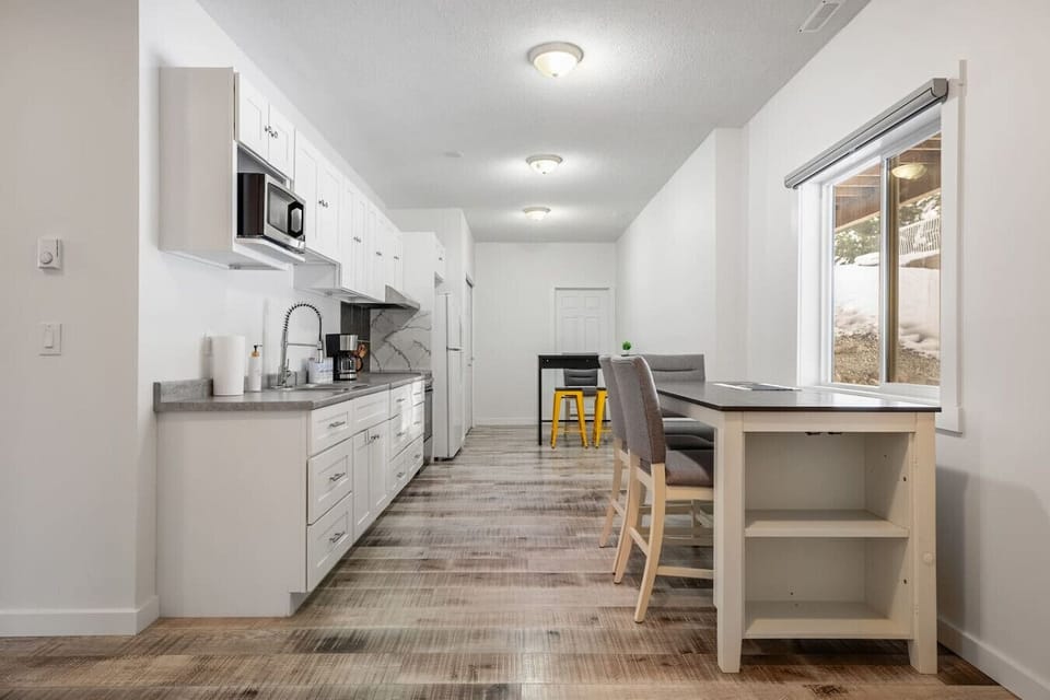 Full kitchen with a drip coffee machine, kettle, fridge, stove, microwave, toaster & kettle.