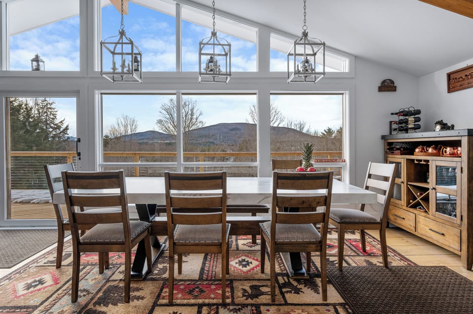 Floor-to-ceiling windows overlooking mountains and bring in natural light 