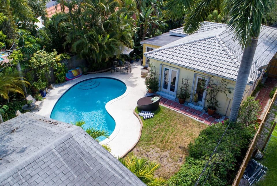 Sparkling pool awaits! This aerial view showcases the refreshing swimming pool in the backyard, perfect for cooling off on a hot day.