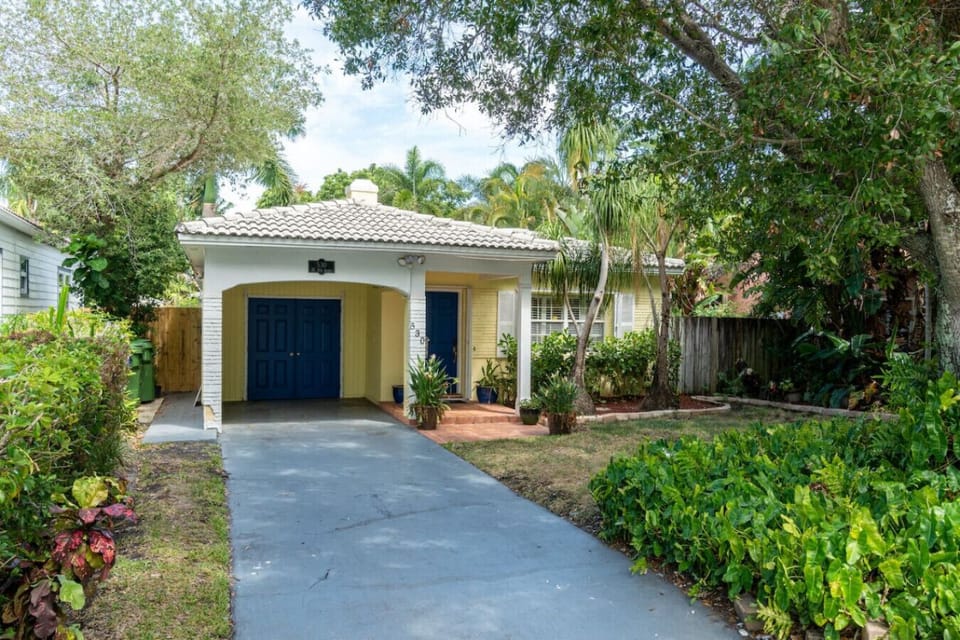 The landscaping around my house includes a driveway, trees, and shrubs, creating a beautiful outdoor space.